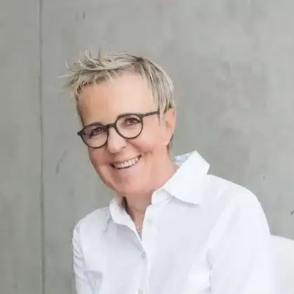 Porträt Annette Jarosch in weißer Bluse mit dunkler Brille